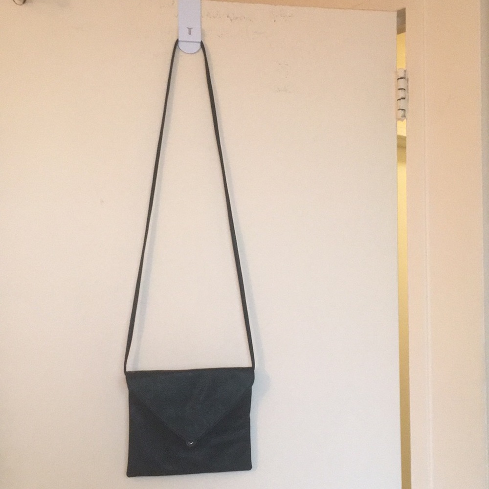 A black leather purse with a black leather strap
